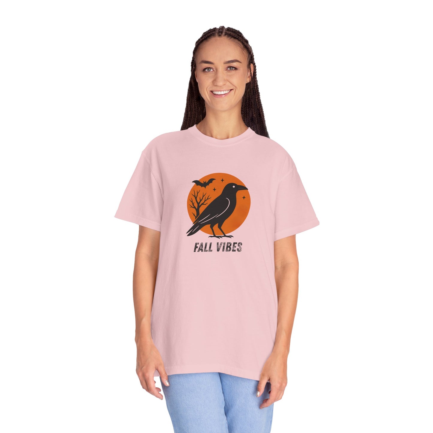Person wearing a pink t-shirt with a 'Fall Vibes' design featuring a black bird and orange background.