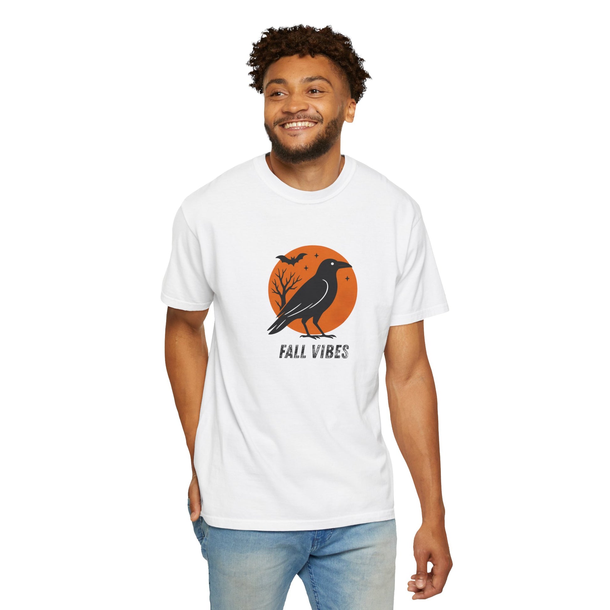 Man wearing a white t-shirt with a 'Fall Vibes' graphic design featuring a crow and moon.