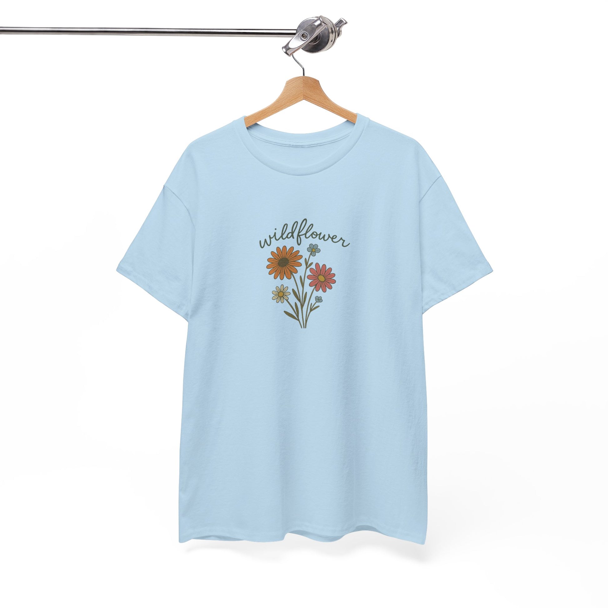Light blue t-shirt with floral design and 'wildflower' text on a hanger against a white background