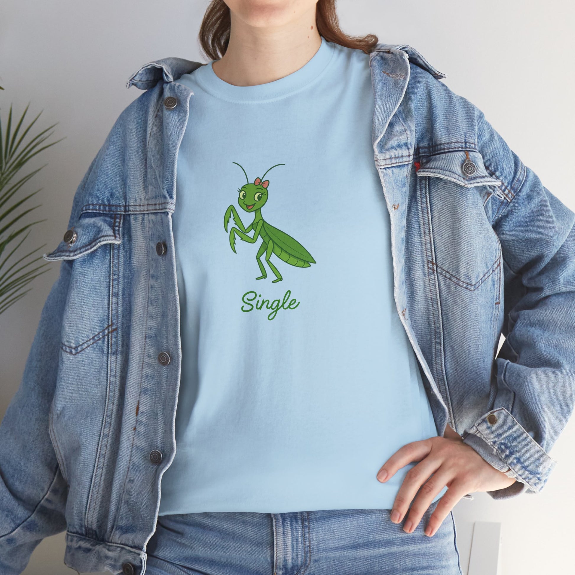 Person wearing a light blue t-shirt with a green praying mantis graphic and the word 'Single'.