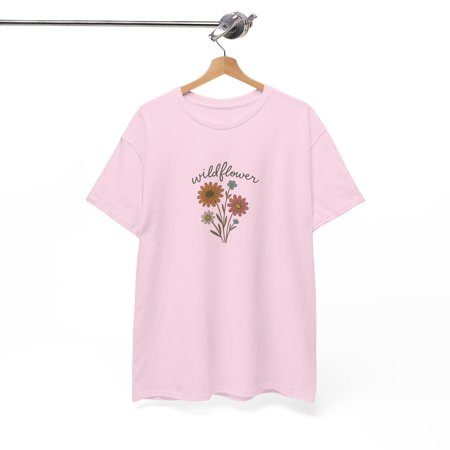 Pink t-shirt with floral design and 'wildflower' text on a hanger against a white background