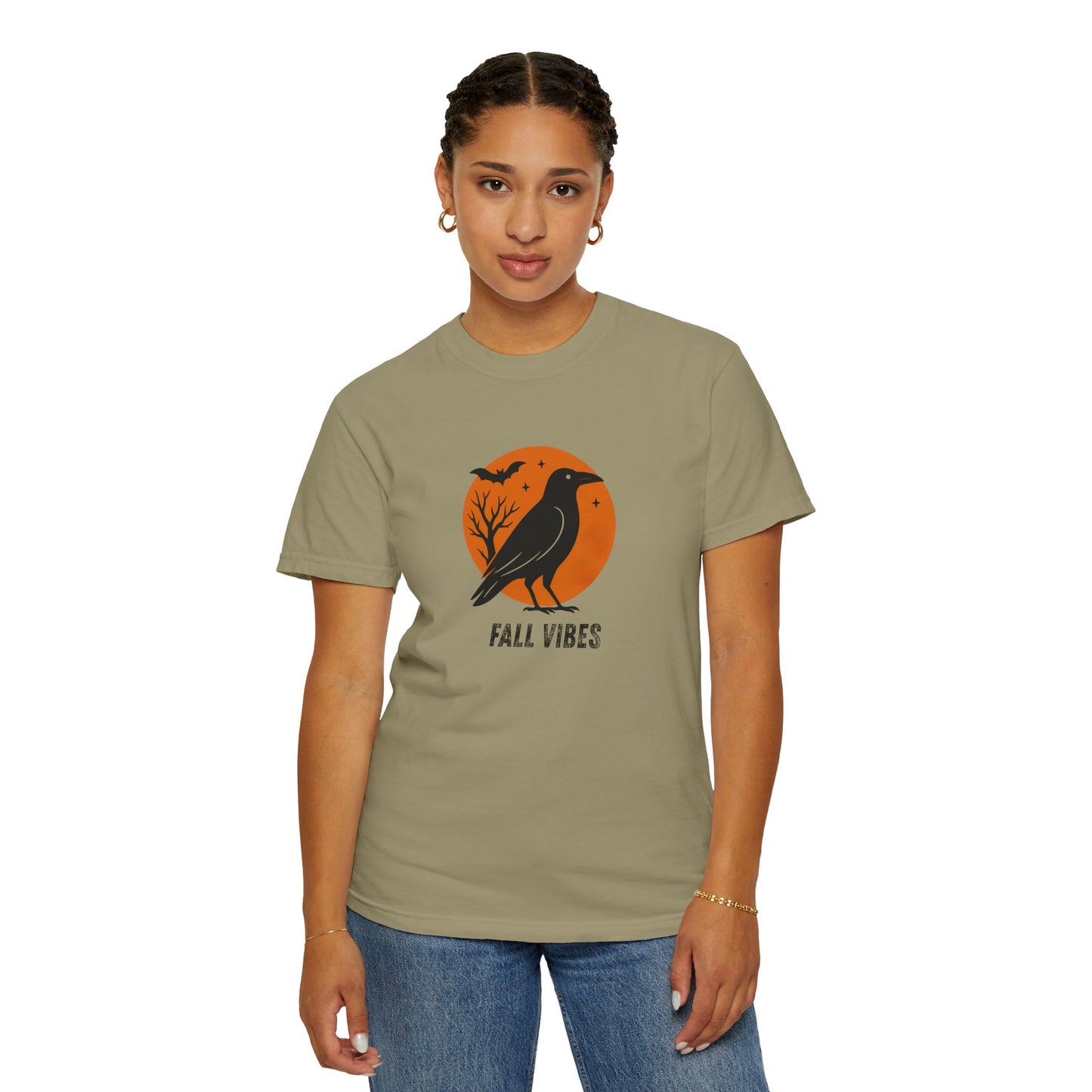 Person wearing a t-shirt with a 'Fall Vibes' design featuring a crow and orange circle on a beige background.