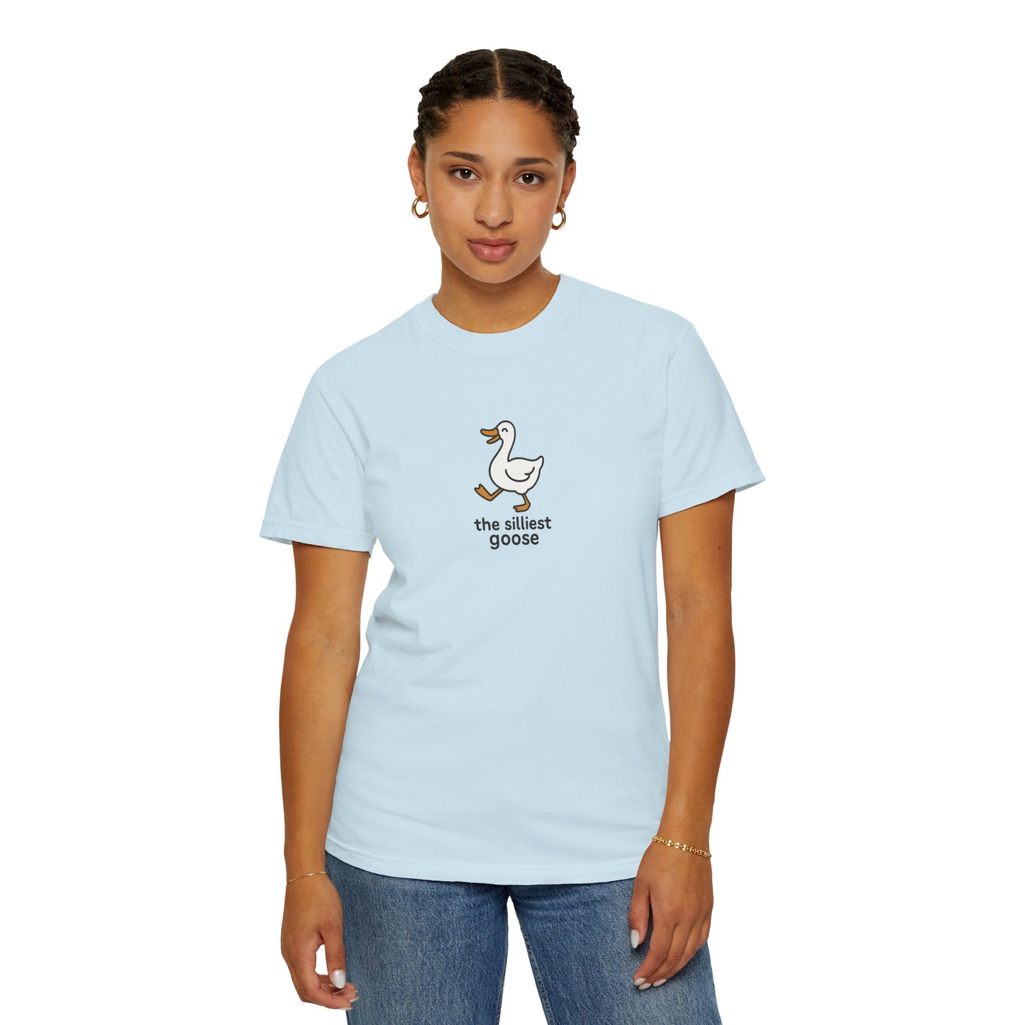 Person wearing a light blue t-shirt with a graphic and text on a white background
