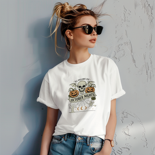 Woman wearing a white t-shirt with Halloween-themed design against a gray wall.