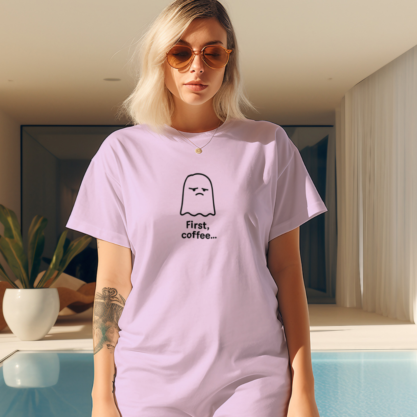 Woman wearing a light purple t-shirt with a graphic design in a modern indoor setting.