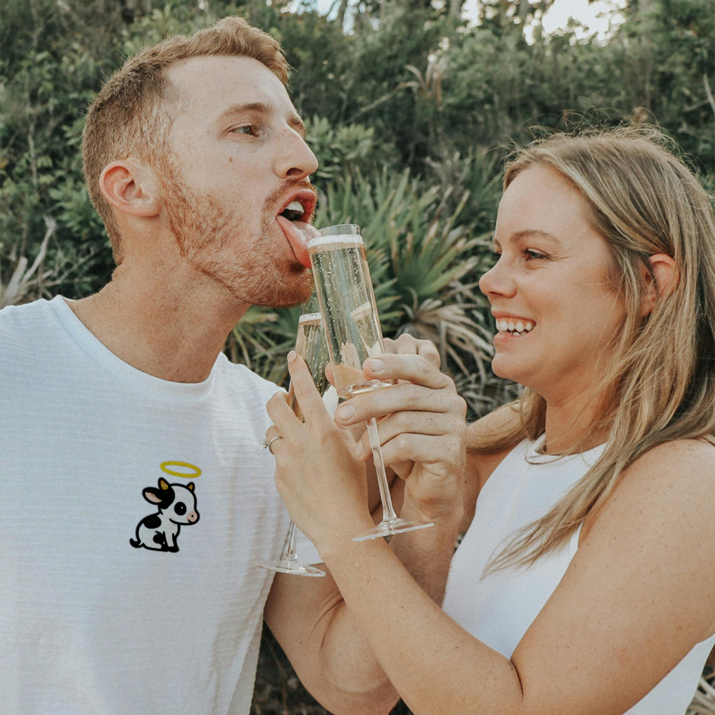 Man and woman outdoors, man drinking from a glass held by woman