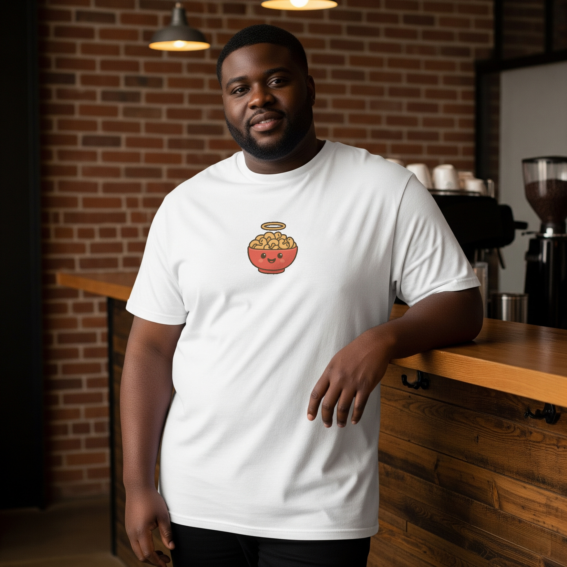 Man wearing a white t-shirt with a logo in a coffee shop setting