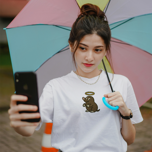 Person holding a colorful umbrella and taking a selfie with a phone.