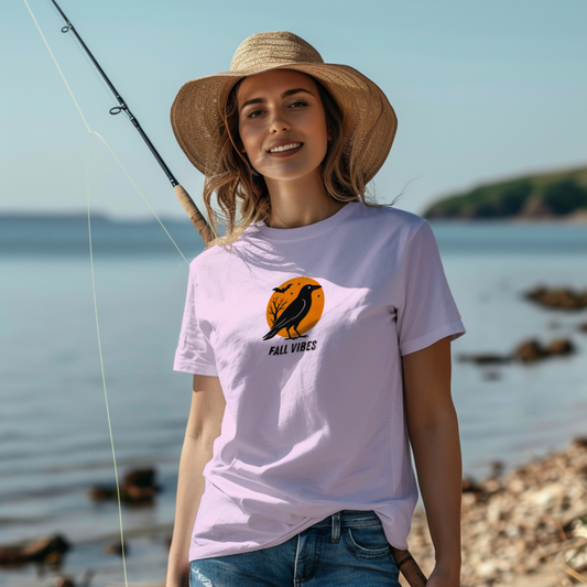 Woman wearing a 'Fall Vibes' t-shirt by a body of water