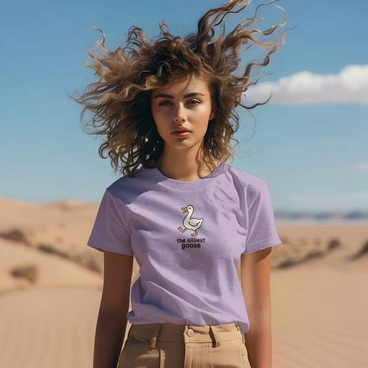 Woman wearing a purple t-shirt with a graphic design in a desert setting