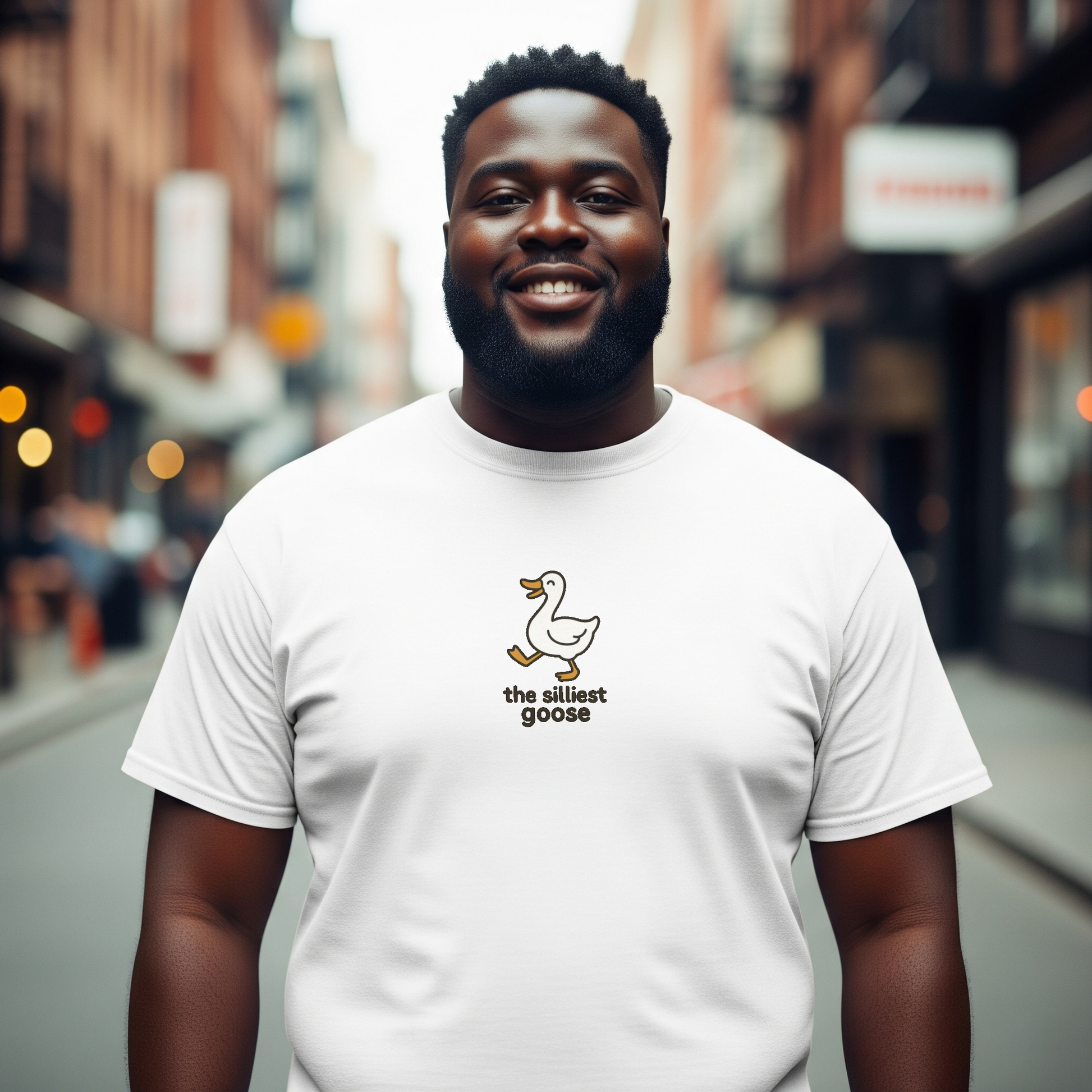 Man wearing a white t-shirt with a logo and text on a city street