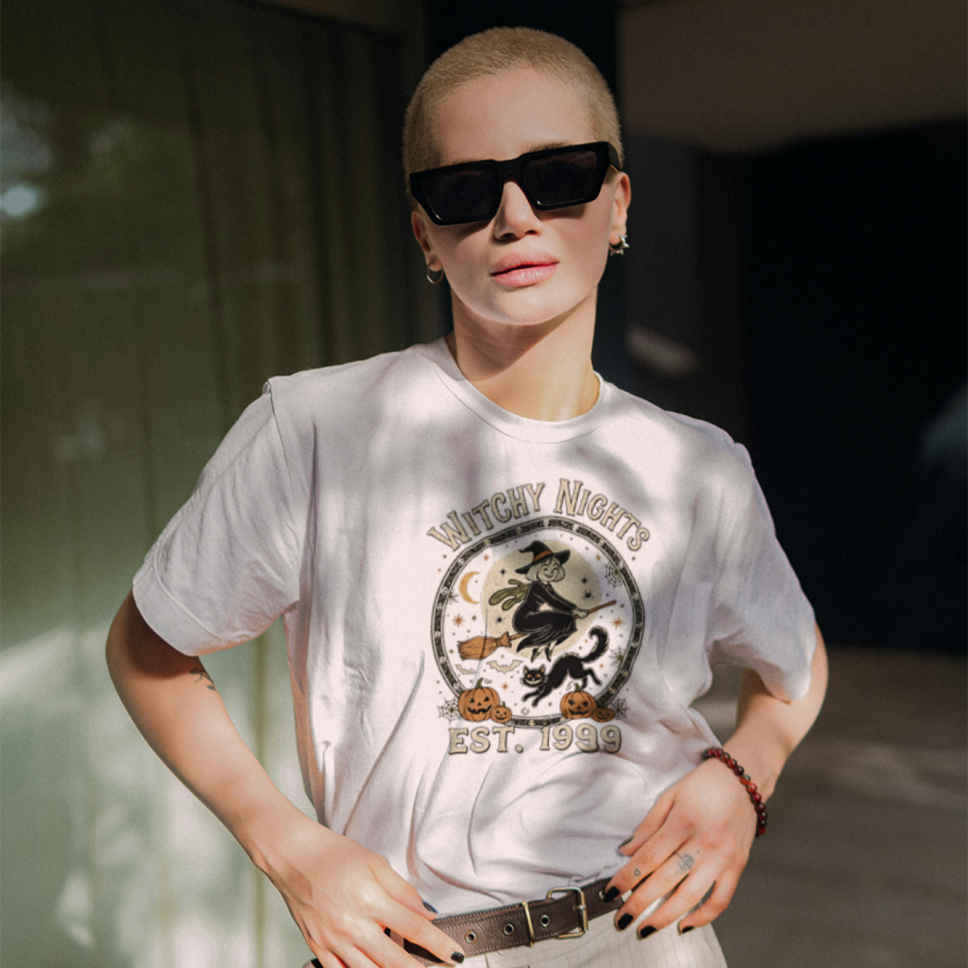 Person wearing a white t-shirt with a graphic design outdoors