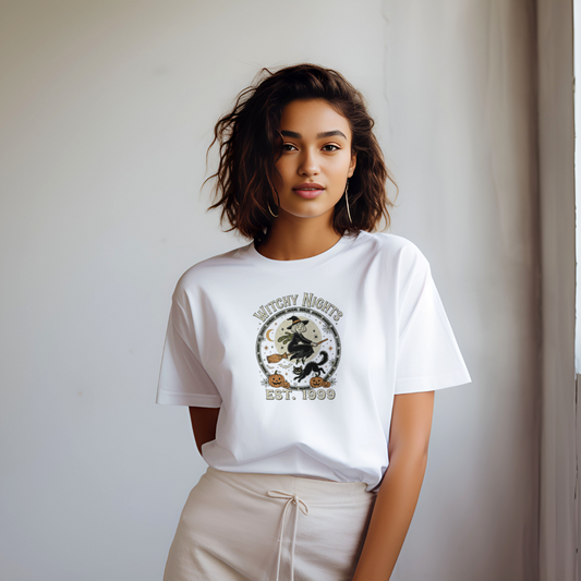 Woman wearing a white t-shirt with a graphic design against a plain background